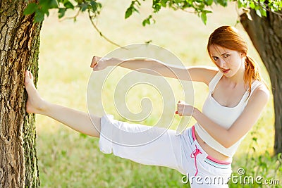 Photo of beautiful young woman doing joga on the wonderful trees Stock Photo