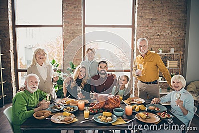 Photo of big family sitting hugging feast table holiday roasted turkey making portrait eight relatives wife husband Stock Photo