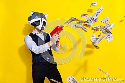 Photo of bizarre freak guy banker racoon mask shoot pistol salary money wear stylish look isolated over shine yellow Stock Photo