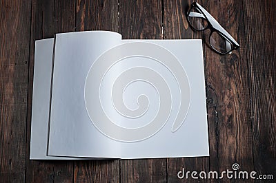 Photo blank. Open square format brochure on a wooden table Stock Photo