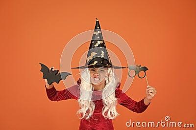 Photo booth props. Small girl in black witch hat. Autumn holiday. Join celebration. Little child in witch costume Stock Photo