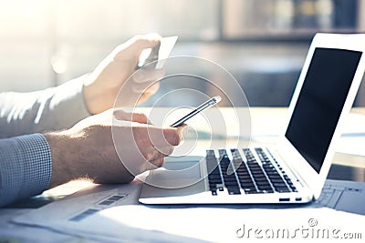 Photo businessman working with generic design notebook smartphone. Online payments credit card, texting keyboard Stock Photo