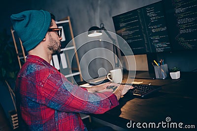 Photo of busy clever coder dressed hat glasses writing JavaScript modern gadget indoors workplace workstation loft Stock Photo