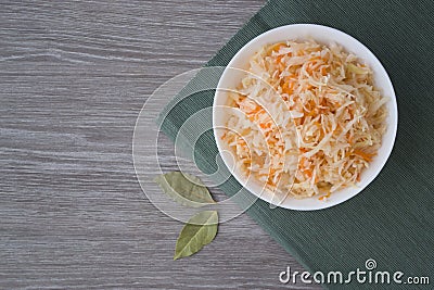 Photo cabbage and carrot salad in a plate on a dark green napkin Stock Photo