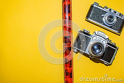 Photo camera and tape for a picture on a yellow background. Layout for designers and photo studio Editorial Stock Photo