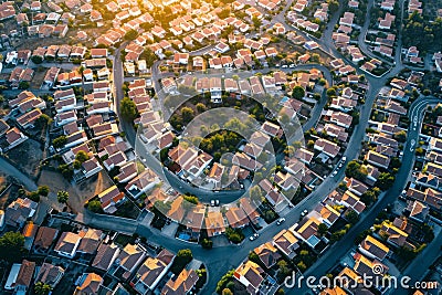 This photo captures an expansive aerial view of a city showcasing a multitude of houses and buildings, An aerial view of a town Stock Photo