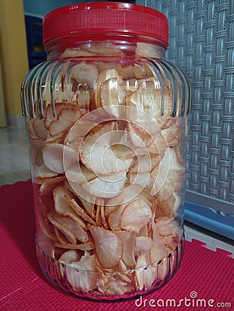 A photo of cassava chips that is contained in a jar Stock Photo