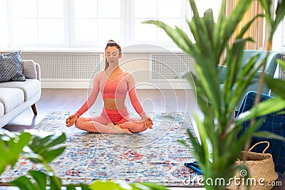 Photo of a caucasian woman meditatin at home. Stock Photo