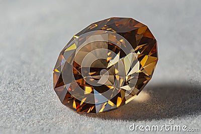 Photo of a Champagne colored Cubic Zirconia gemstone, cut in the shape of a Standard Round Brilliant design PvNiel on a white ve Stock Photo
