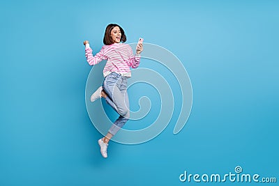 Photo of charming lucky lady dressed pink pullover jumping high typing modern device empty space isolated blue color Stock Photo