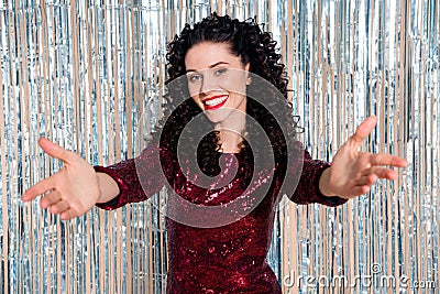 Photo of charming positive girl raise arms to camera inviting you beaming smile isolated on glowing decoration Stock Photo