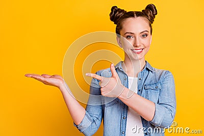 Photo of charming pretty young teen lady two buns direct finger open arm show novelty shopping product low price amazing Stock Photo