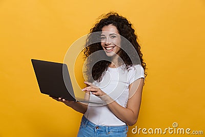 Photo of charming woman 20s wearing casual clothes smiling while Stock Photo