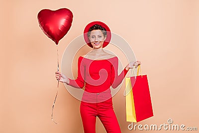 Photo of cheerful attractive positive young woman hold shopper bag balloon sale isolated on beige color background Stock Photo