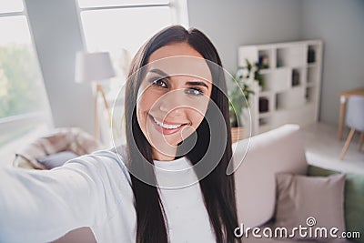 Photo cheerful attractive young woman take selfie camera in living room wear white sweater indoors in house Stock Photo