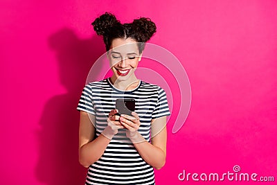 Photo of cheerful cute nice charming girlfriend browsing through her phone isolated over vivid fuchsia bright color Stock Photo