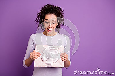 Photo of cheerful excited funky funny woman looking over her present smiling toothily adoring unexpected box isolated Stock Photo