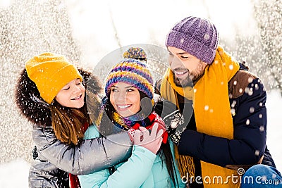 Photo of cheerful family happy positive smile hug cuddle embrace look each other fly air snow walk park weekend Stock Photo