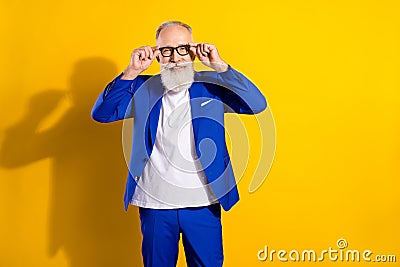 Photo of cheerful grey beard elder man wear spectacles blue jacket isolated on vivid yellow color background Stock Photo