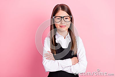 Photo of cheerful happy positive small girl hold hands crossed confident glasses on pink color background Stock Photo