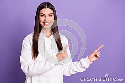 Photo of cheerful happy young woman point finger index empty space smile isolated on purple color background Stock Photo
