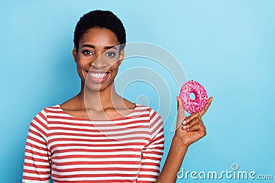 Photo of cheerful healthy diet advertiser lady hold tasty donut wear striped shirt isolated blue color background Stock Photo