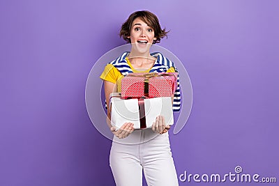 Photo of cheerful lovey cute lady wear stylish striped tied clothes hold packages preparing event isolated on purple Stock Photo