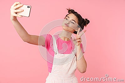 Photo of cheerful nice girl taking selfie and gesturing peace sign Stock Photo
