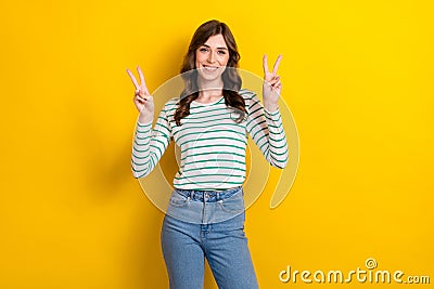 Photo of cheerful optimist friendly peaceful young girl wear striped white shirt show v-sign fingers hello symbol Stock Photo