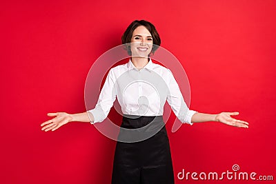 Photo of cheerful positive young woman welcome young open hands hostess isolated on red color background Stock Photo