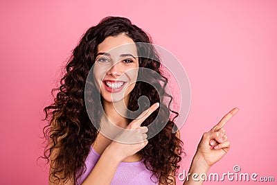 Photo of cheerful pretty charming fascinating kind good girl pointing at your best choice while isolated with pink Stock Photo