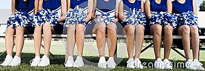 Cheerleading Squad Sitting on Bench Stock Photo