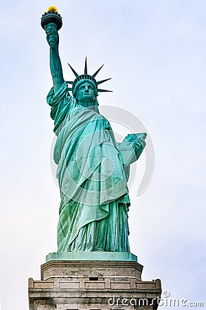 Photo close-up of the Statue of Liberty on a sunny day and blue sky with clouds. Liberty Island. NYC, USA Stock Photo