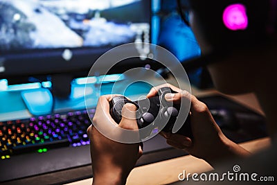 Photo closeup of asian gamer boy playing video games online on c Stock Photo