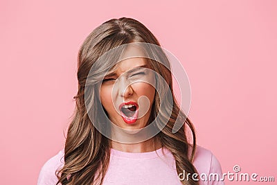 Photo closeup of displeased frustrated woman with long curly hair in basic t-shirt grimacing or screaming in outrage, isolated Stock Photo