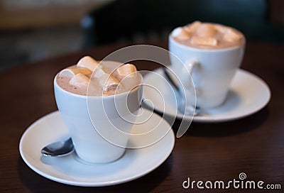 Photo of cocoa with marshmallows. Two cups of cocoa on a table in a cafe. Morning coffee Stock Photo