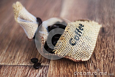 Photo of coffee.Bag with coffee beans on the wood backround.Food photo. Stock Photo