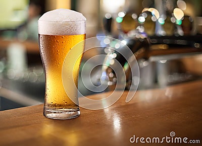 Photo of cold beer glass on a bar. Stock Photo