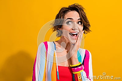Photo of comic girl brown bob hair touching cheek comic reaction look novelty disco party surprised isolated on yellow Stock Photo