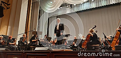 Photo director and musicians. Musical concert in the Philharmonic. Violin player. Music concert background Editorial Stock Photo