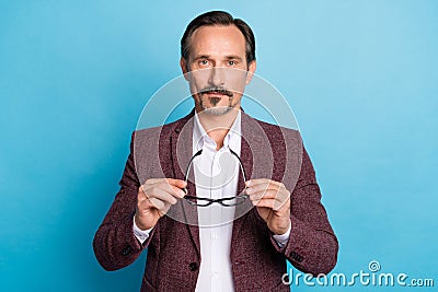 Photo of confident man take off glasses eyesight enhancement concept wear red blazer isolated blue color background Stock Photo