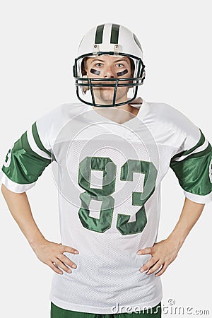 Portrait of confident young man wearing football uniform against gray background Stock Photo