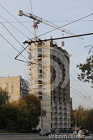 Photo of the construction of a high-rise modern building on a city street. Editorial Stock Photo