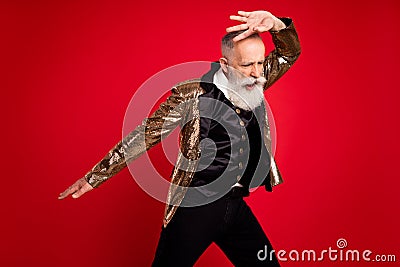 Photo of cool grey beard elder dancer man wear gold suit on red color background Stock Photo