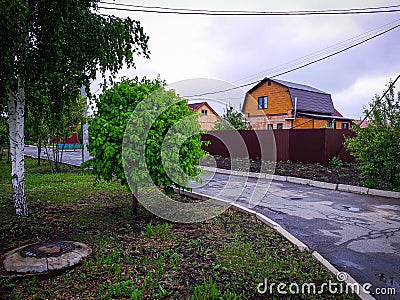 Holiday village cottages, trees, house, alley Stock Photo