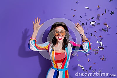 Photo of crazy excited retro lady enjoying occasion in discotheque with flying confetti isolated purple color background Stock Photo
