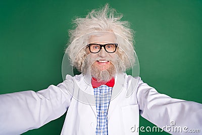 Photo of crazy genius mature inventor dressed white uniform bow tie glasses tacking selfie isolated green color Stock Photo