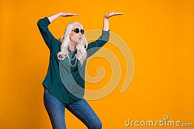 Photo of crazy grandma lady music lover senior retro party cool look dancing strange youngster moves wear green shirt Stock Photo