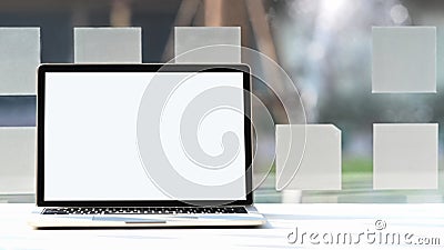 Photo of Cropped black computer laptop with white blank screen. Stock Photo