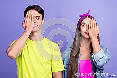 Photo of curious couple palm cover one eye look each other wear pin-up outfit isolated violet color background Stock Photo